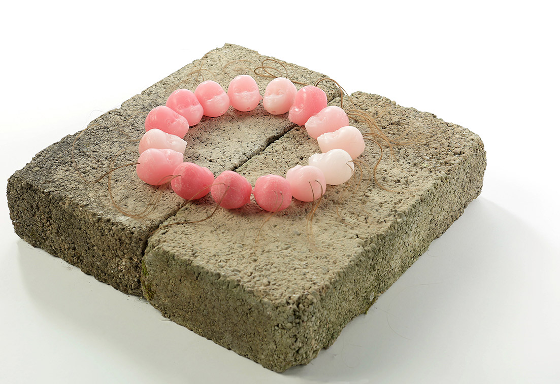 Untitled (Fourteen wax heads), 12 x 42 x 42cm concrete, wax & hair